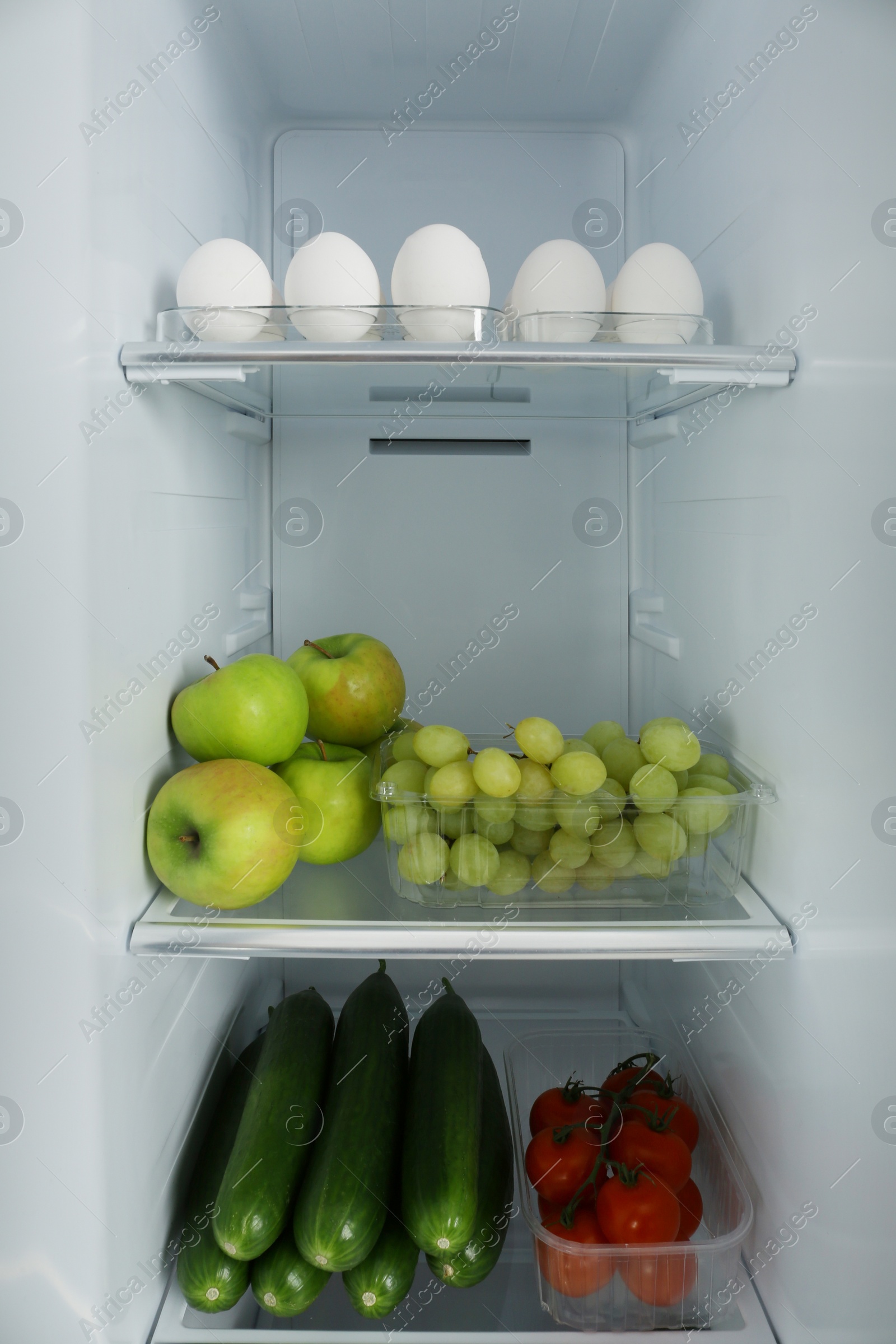 Photo of Open refrigerator full of different fresh products