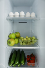 Photo of Open refrigerator full of different fresh products