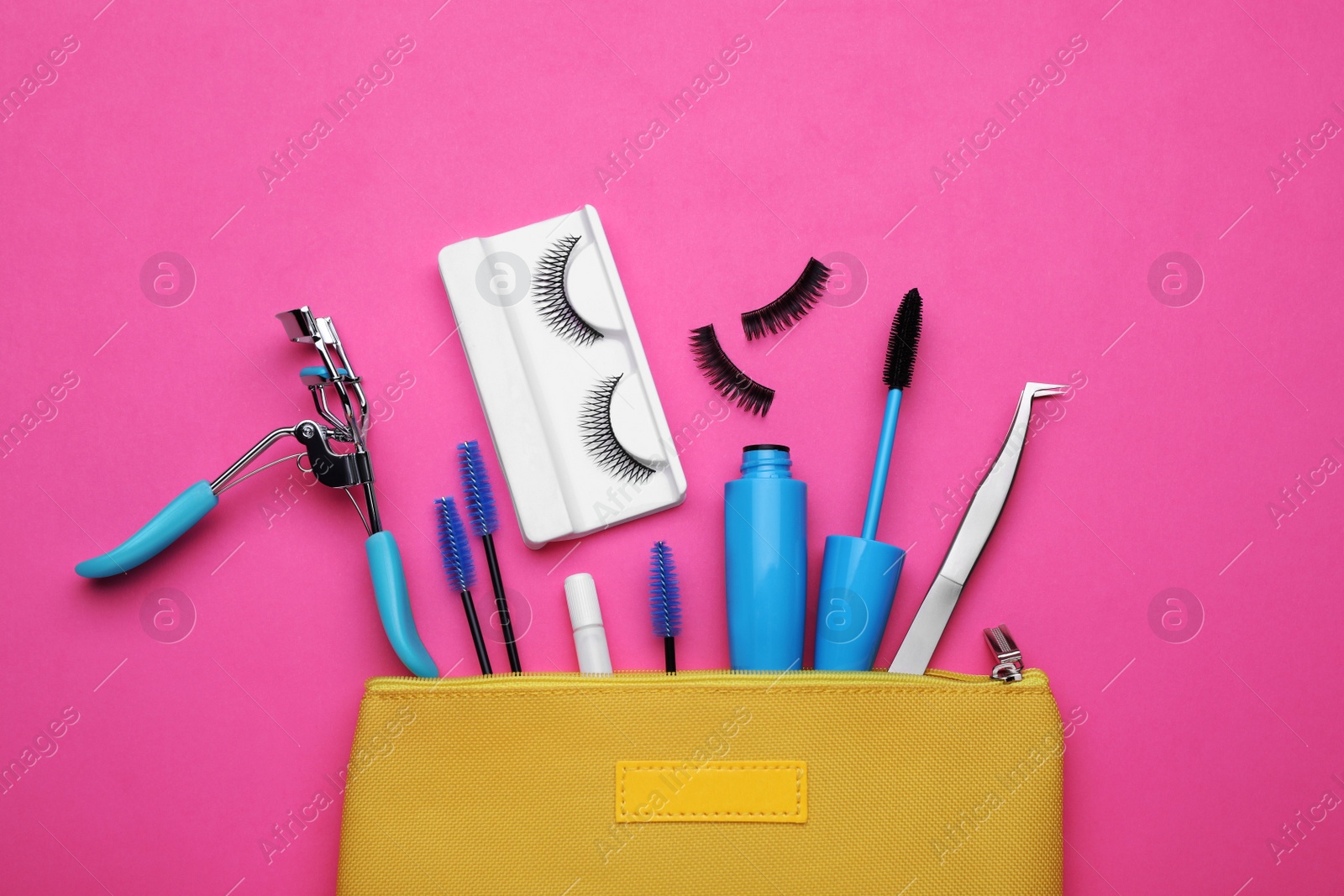 Photo of Flat lay composition with fake eyelashes, brushes and tools on pink background