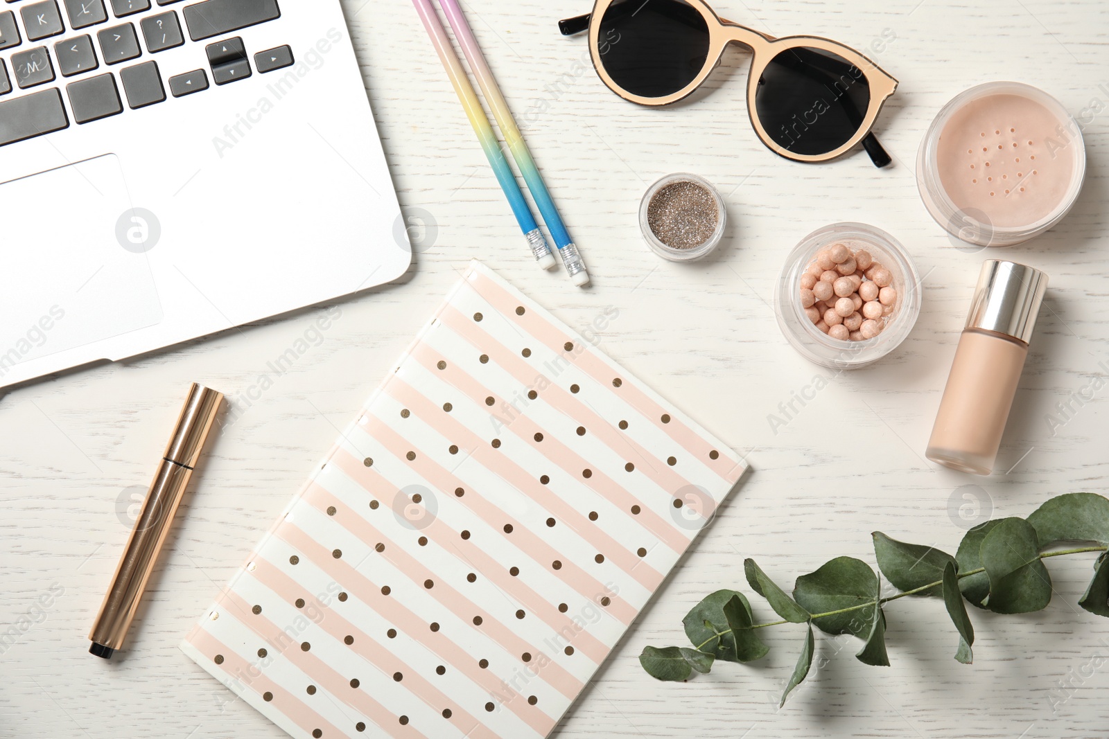 Photo of Flat lay composition with laptop, cosmetics and notebook on wooden table. Beauty blogger's workplace