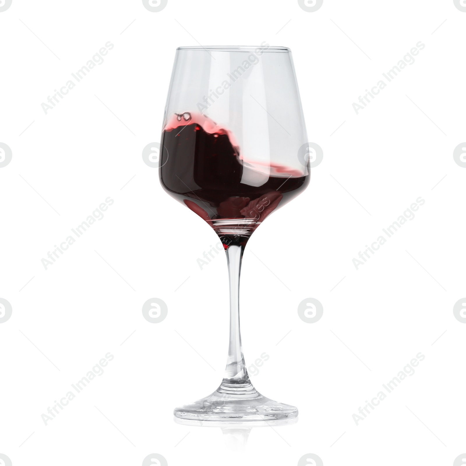 Image of Red wine splashing in glass on white background