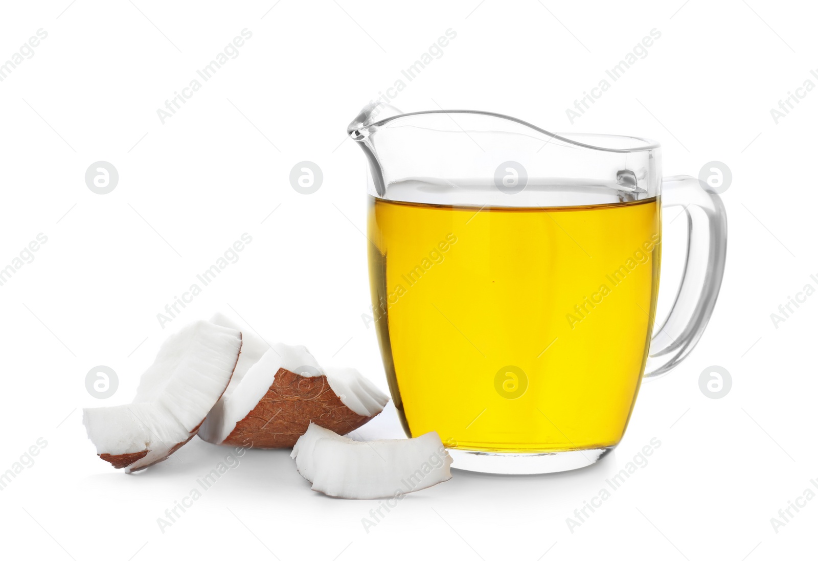 Photo of Ripe coconut and oil in pitcher on white background. Healthy cooking