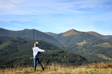 Photo of Young woman in beautiful mountains on sunny day
