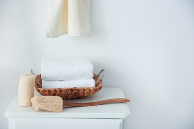 Photo of Clean towels and sponges on table indoors