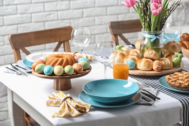 Photo of Festive Easter table setting with traditional meal at home