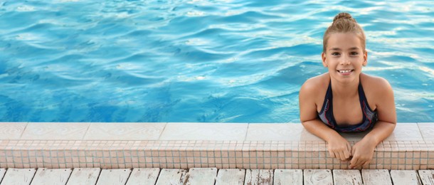 Image of Happy little girl in swimming pool on sunny day, space for text. Banner design