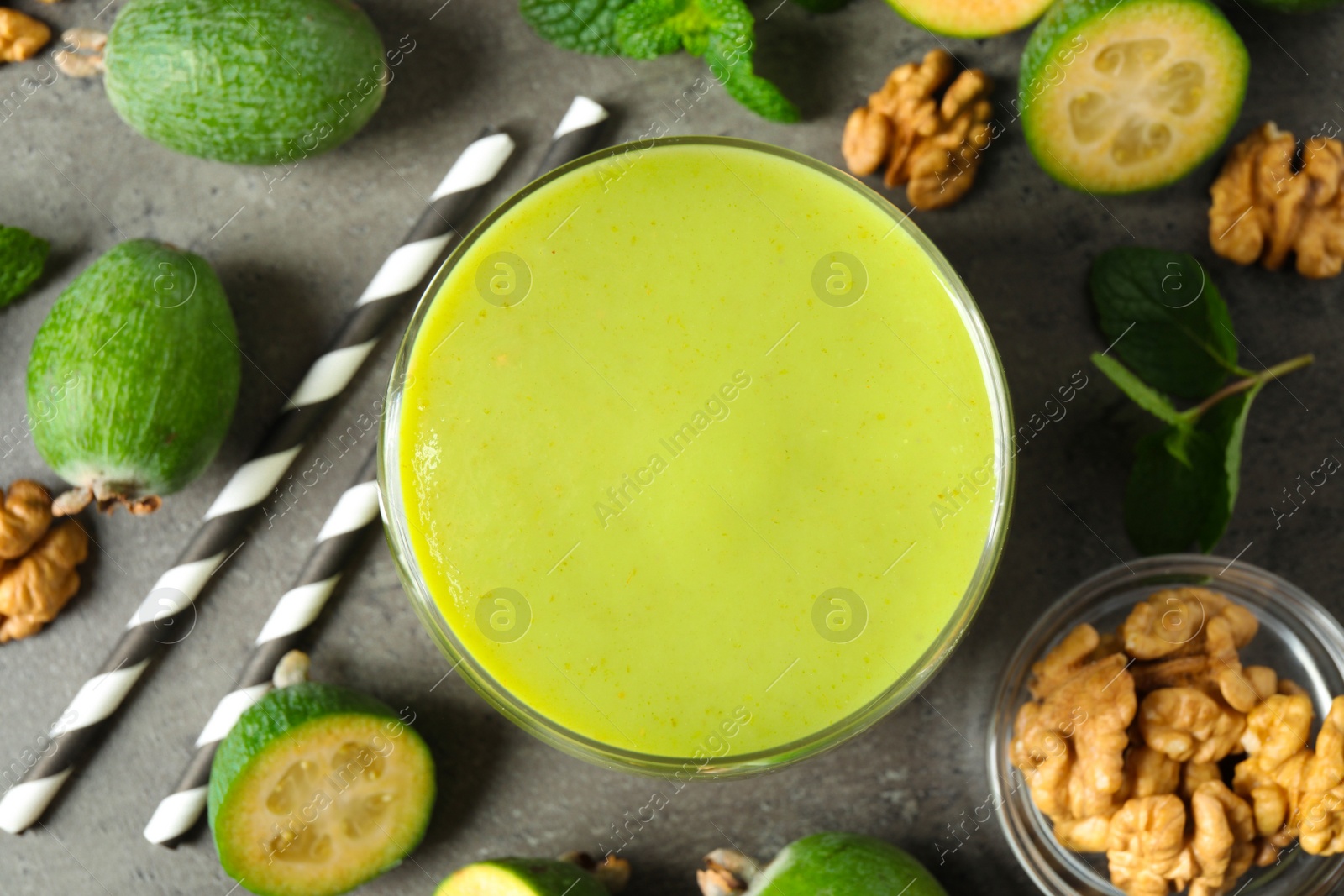 Photo of Flat lay composition with fresh feijoa smoothie on grey table