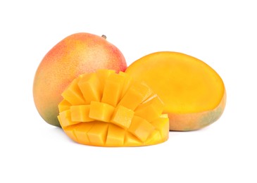 Photo of Delicious whole and cut mangoes on white background