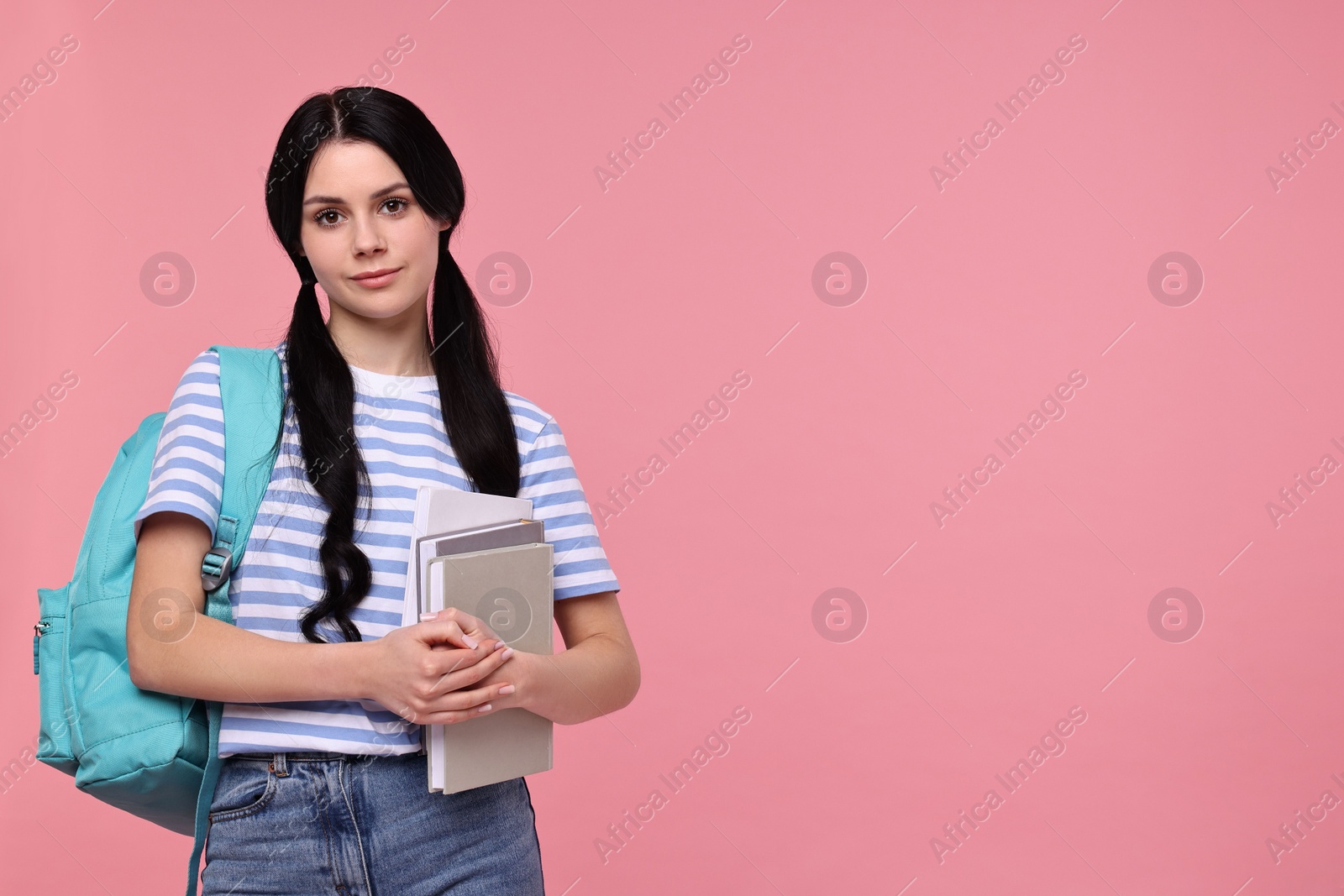 Photo of Student with books and backpack on pink background. Space for text