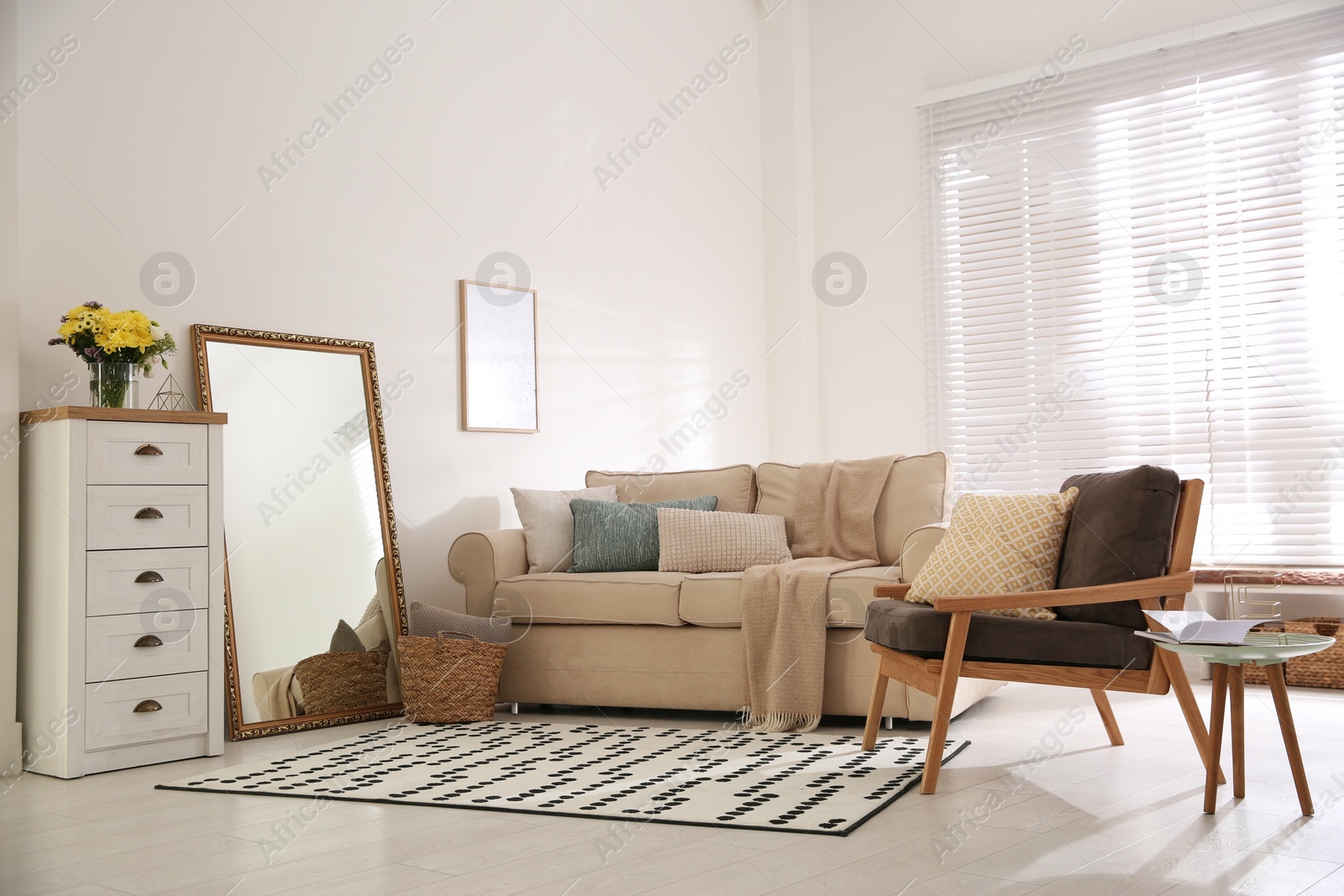 Photo of Large mirror and comfortable sofa in living room. Interior design