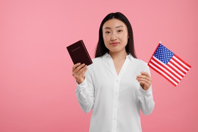 Photo of Immigration to United States of America. Woman with passport and flag on pink background, space for text
