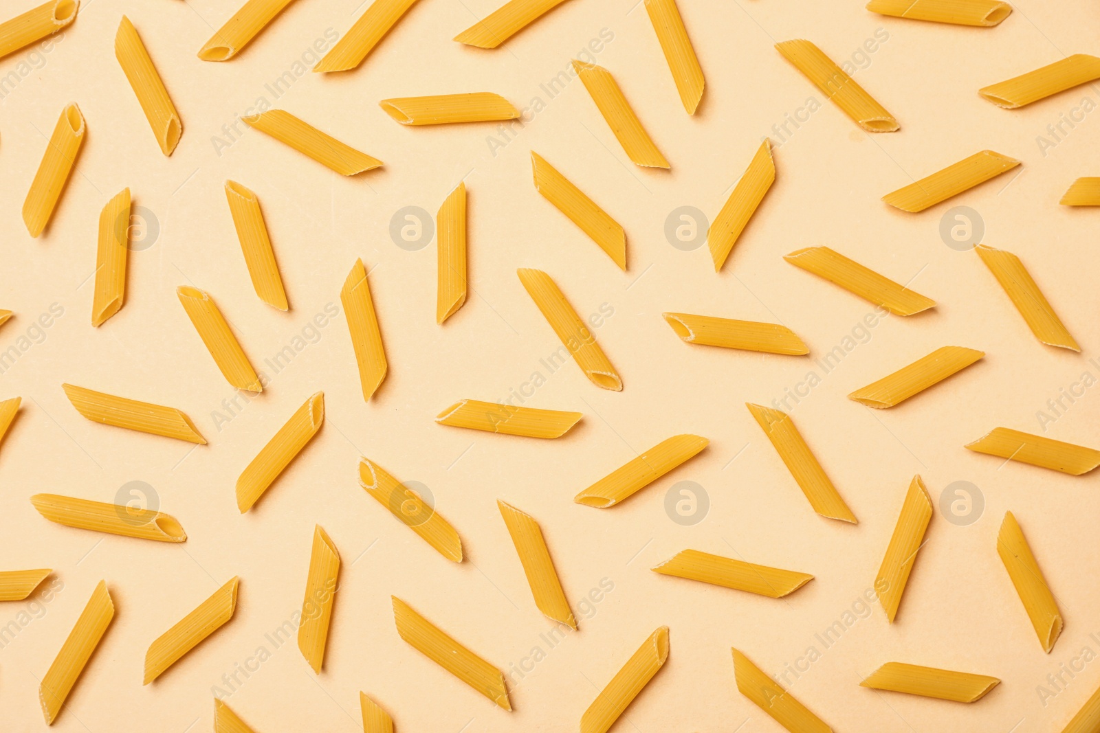 Photo of Flat lay composition with raw pasta on color background