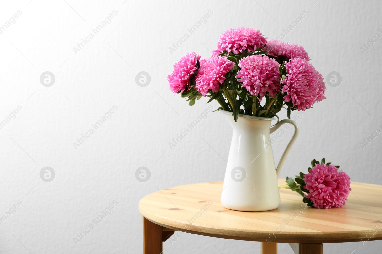 Photo of Bouquet of beautiful asters on table, space for text. Autumn flowers