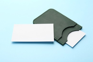 Leather business card holder with blank cards on light blue background