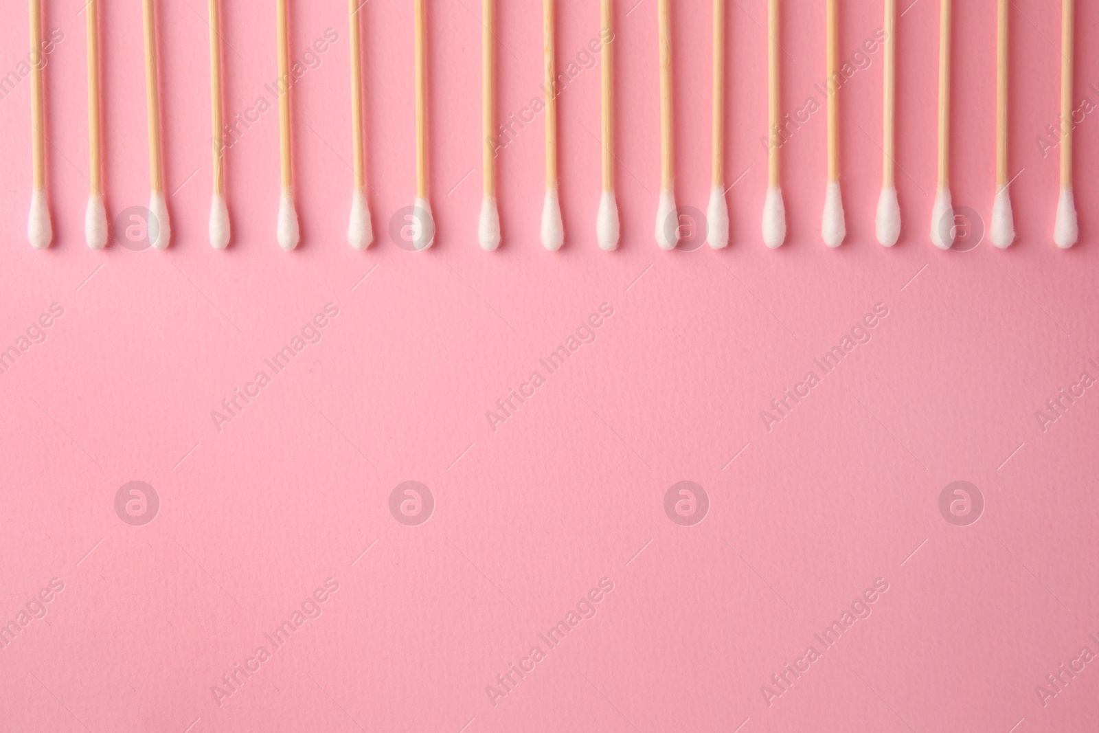 Photo of Many clean cotton buds on pink background, flat lay. Space for text