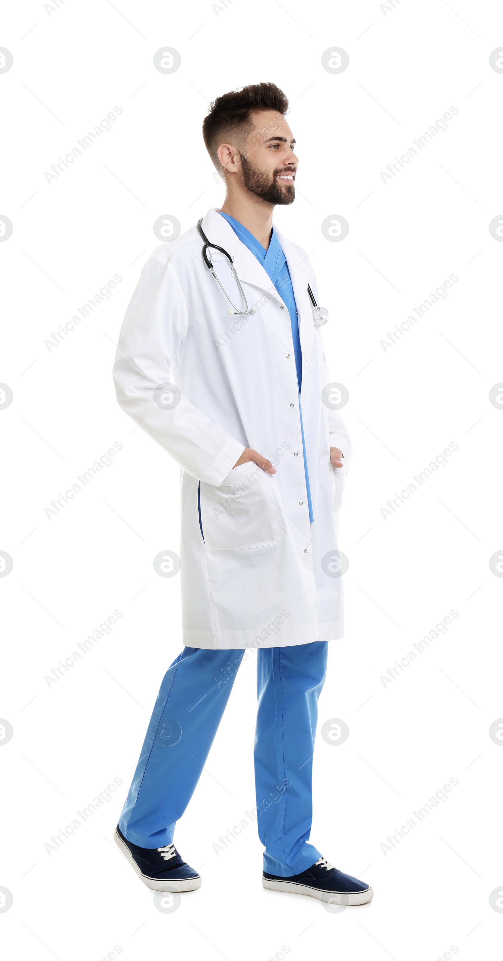 Photo of Young male doctor in uniform isolated on white