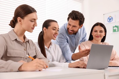 Photo of Happy teacher giving lesson in driving school