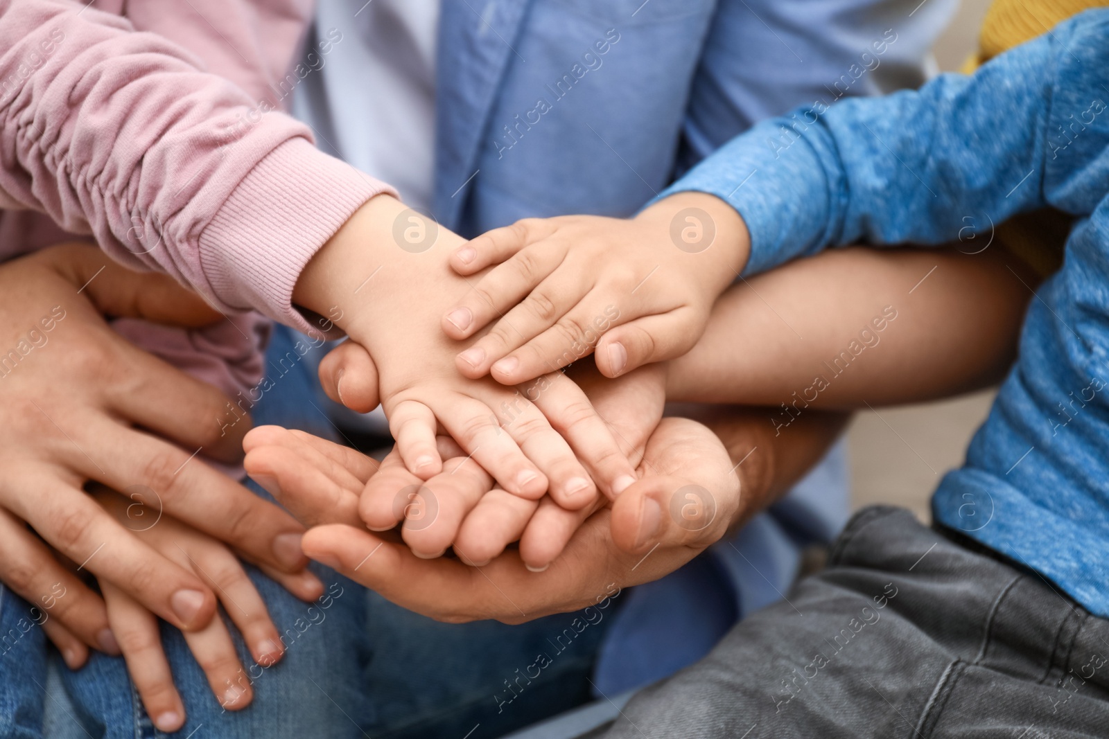 Photo of Closeup view of happy family holding hands