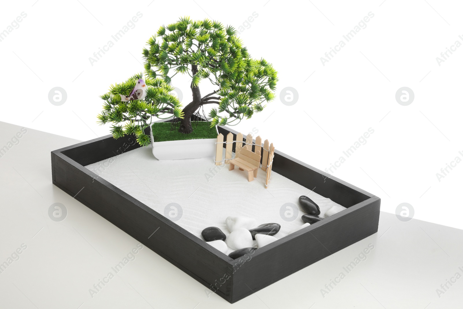 Photo of Beautiful miniature zen garden isolated on white