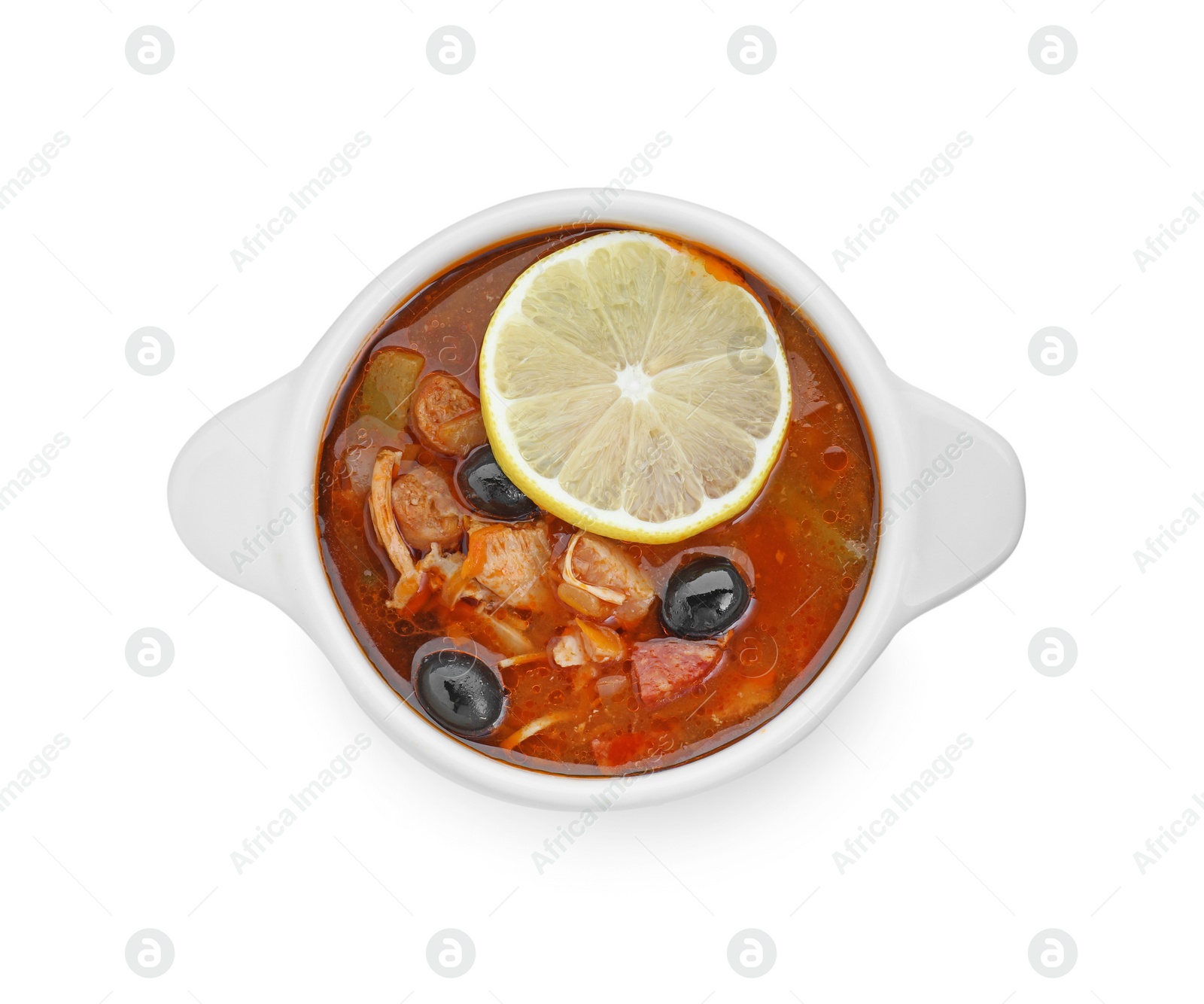 Photo of Meat solyanka soup with sausages, olives and vegetables in bowl isolated on white, top view