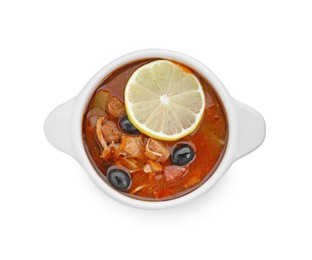 Meat solyanka soup with sausages, olives and vegetables in bowl isolated on white, top view