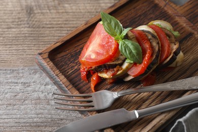 Delicious ratatouille served with basil on wooden table, closeup