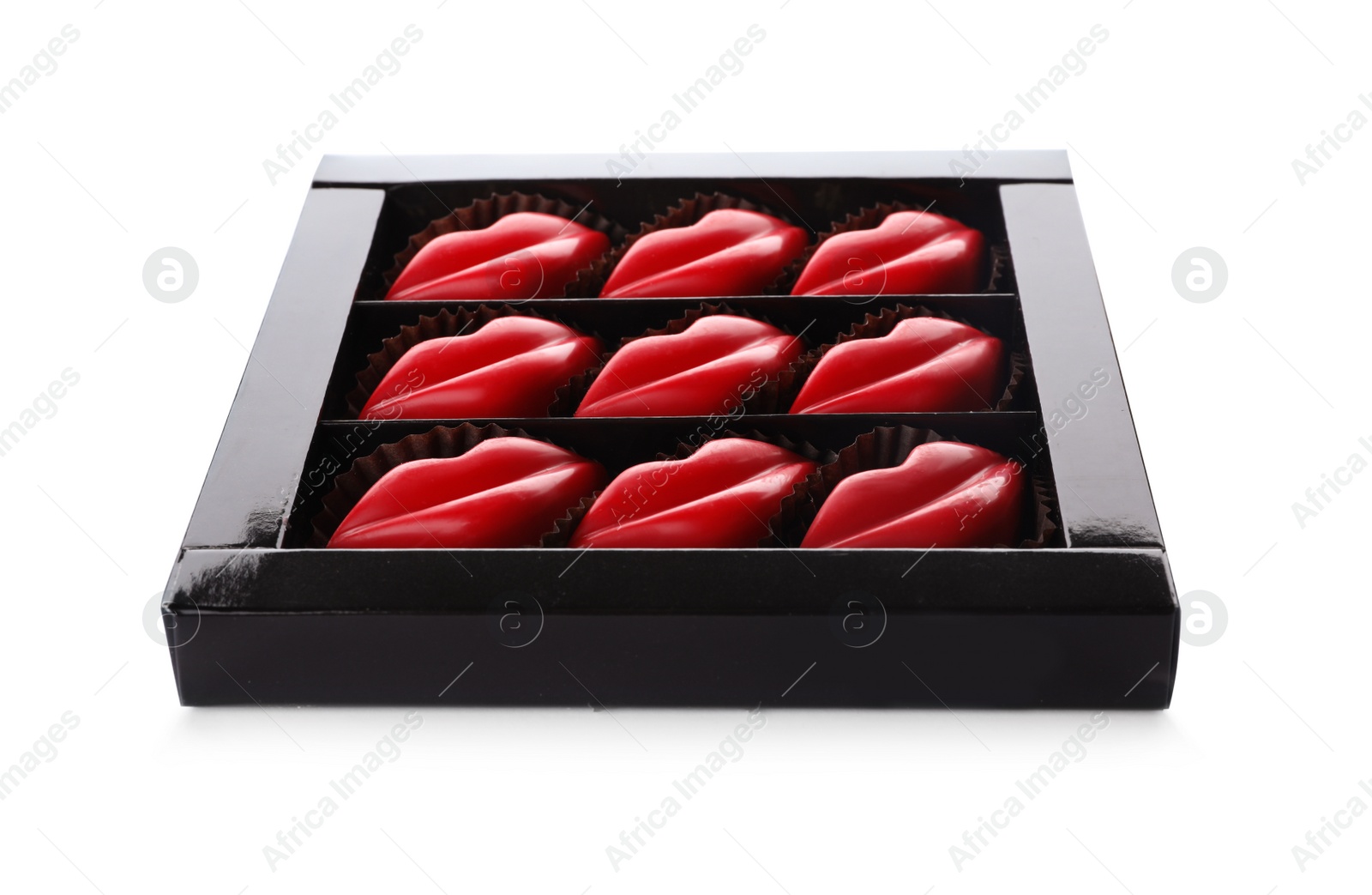 Photo of Box with tasty lip shaped chocolate candies isolated on white