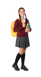 Teenage girl in school uniform with books and backpack on white background