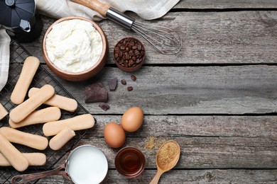 Photo of Flat lay composition with tiramisu ingredients on wooden table. Space for text