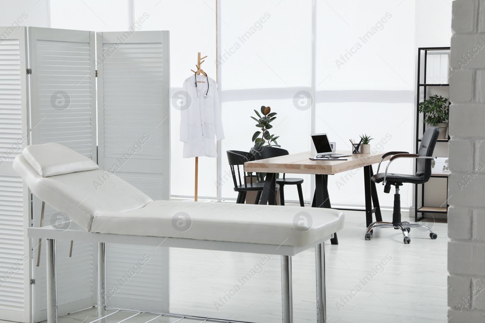 Photo of Modern medical office interior with couch. Doctor's workplace
