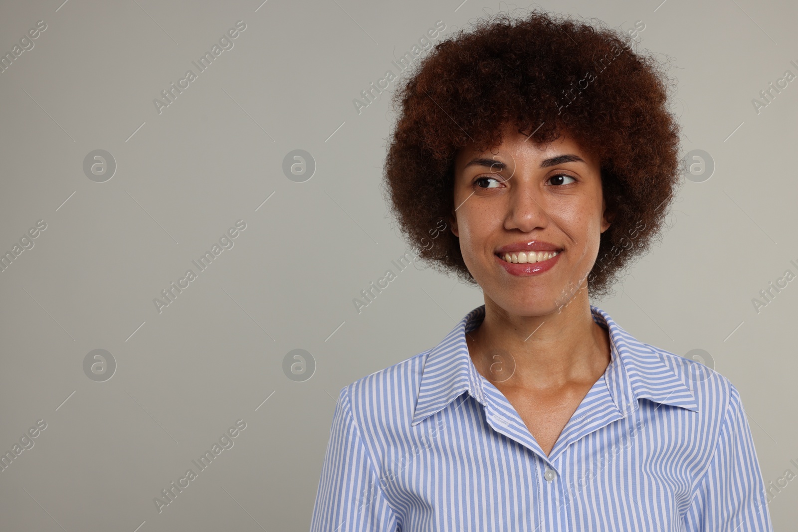 Photo of Portrait of happy young woman on grey background. Space for text