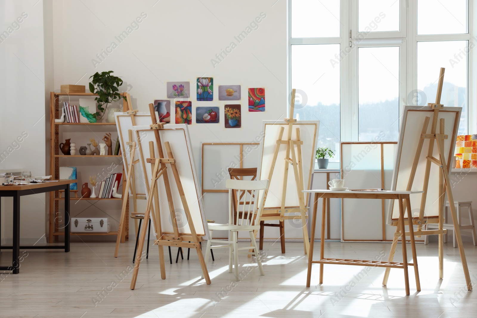 Photo of Stylish artist's studio interior with easels and canvases. Creative hobby