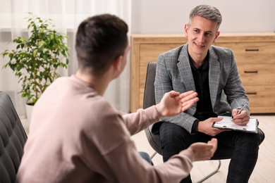 Photo of Professional psychotherapist working with patient in office