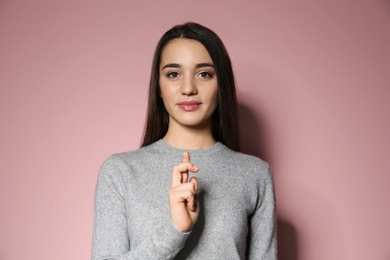 Photo of Woman using sign language on color background