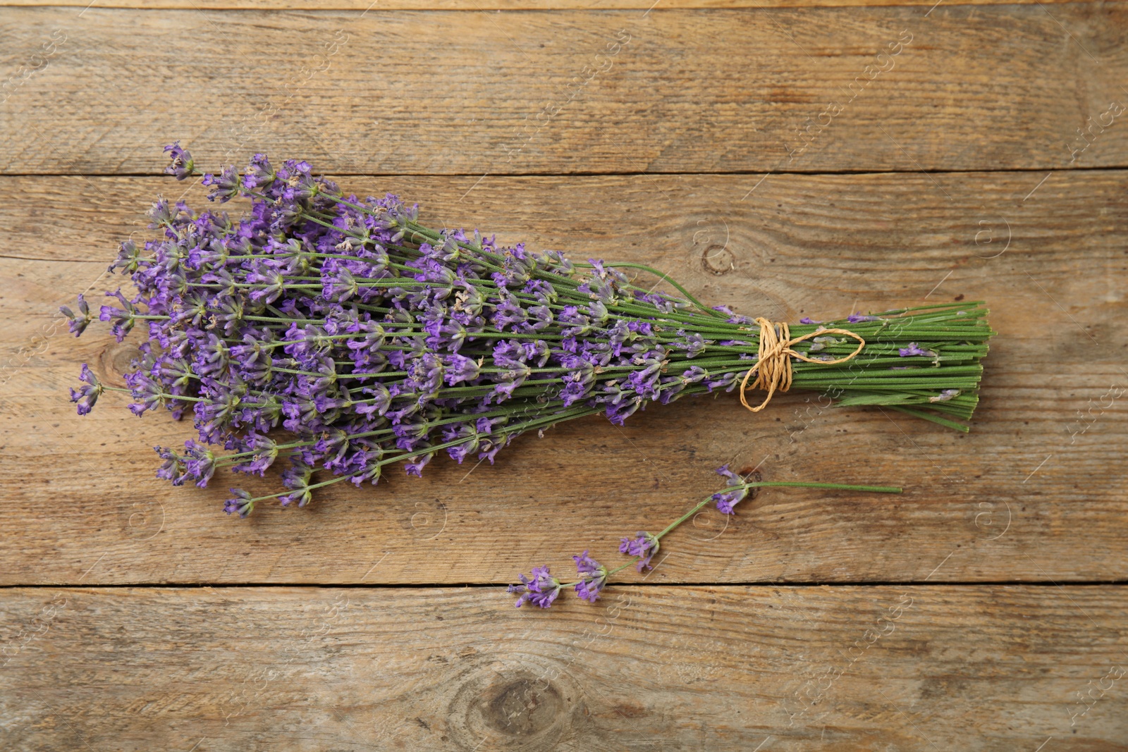 Photo of Beautiful tender lavender flowers on wooden table, top view
