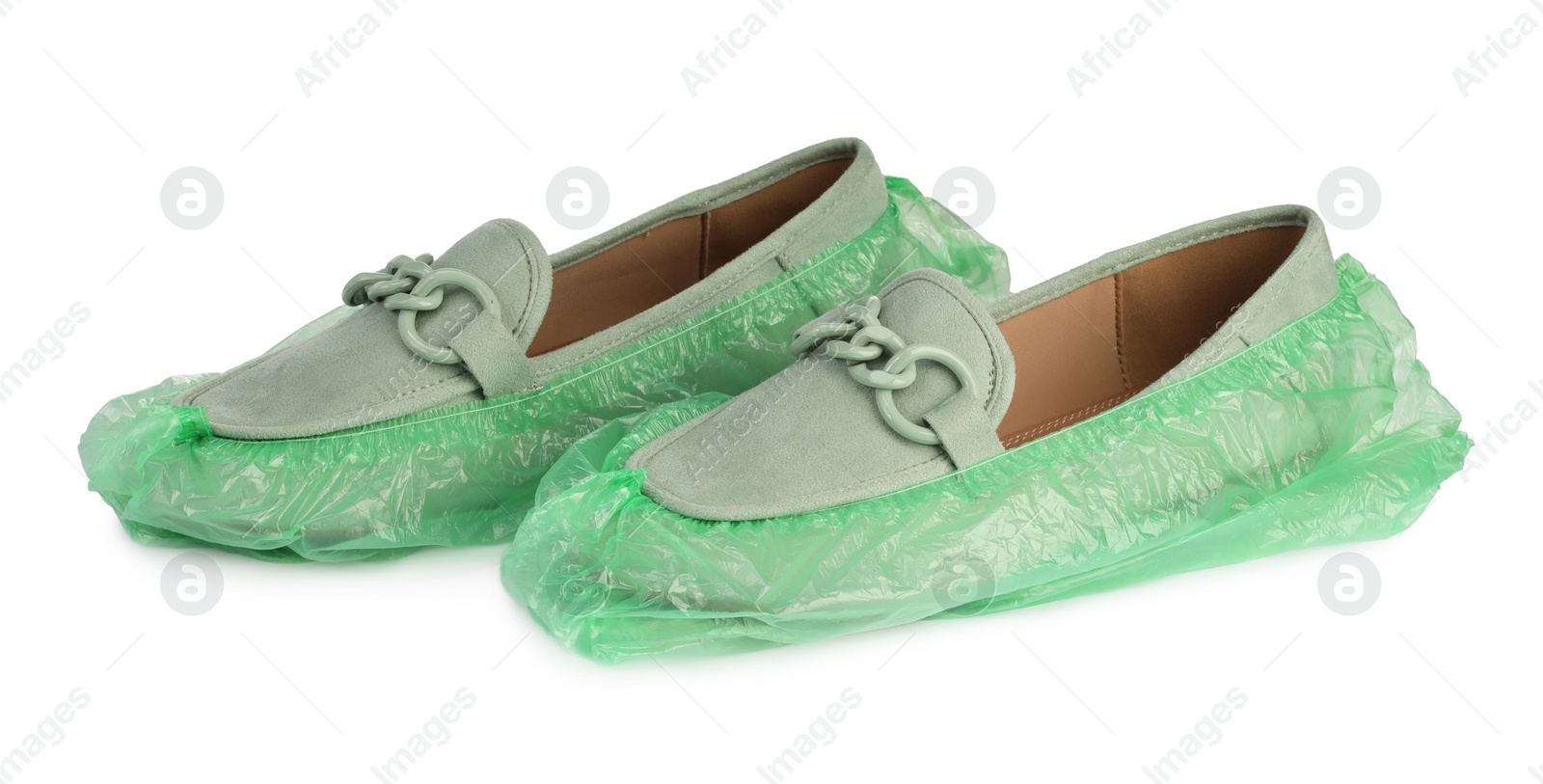 Photo of Women's mules in green shoe covers isolated on white