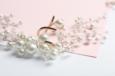 Photo of Elegant jewelry with pearls on color background, closeup