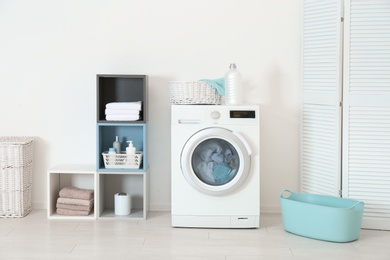 Photo of Washing of different towels in modern laundry room