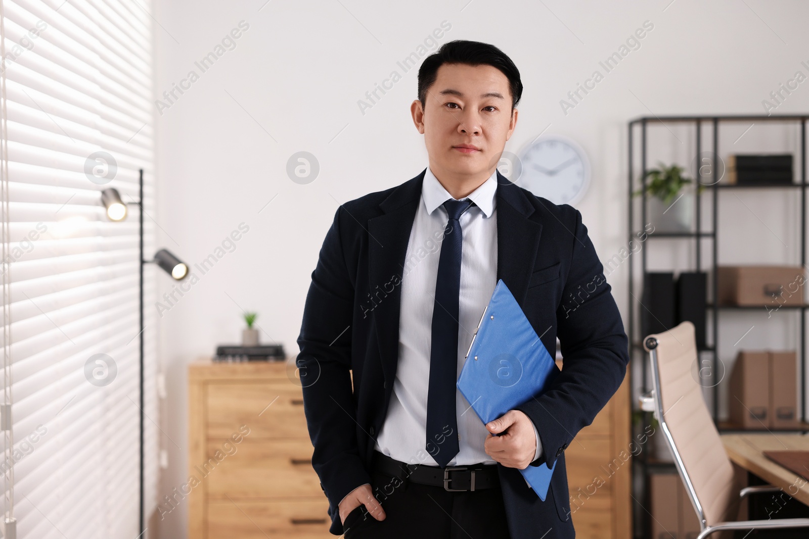 Photo of Portrait of confident notary with clipboard in office