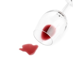 Photo of Transparent glass and spilled exquisite red wine on white background, top view