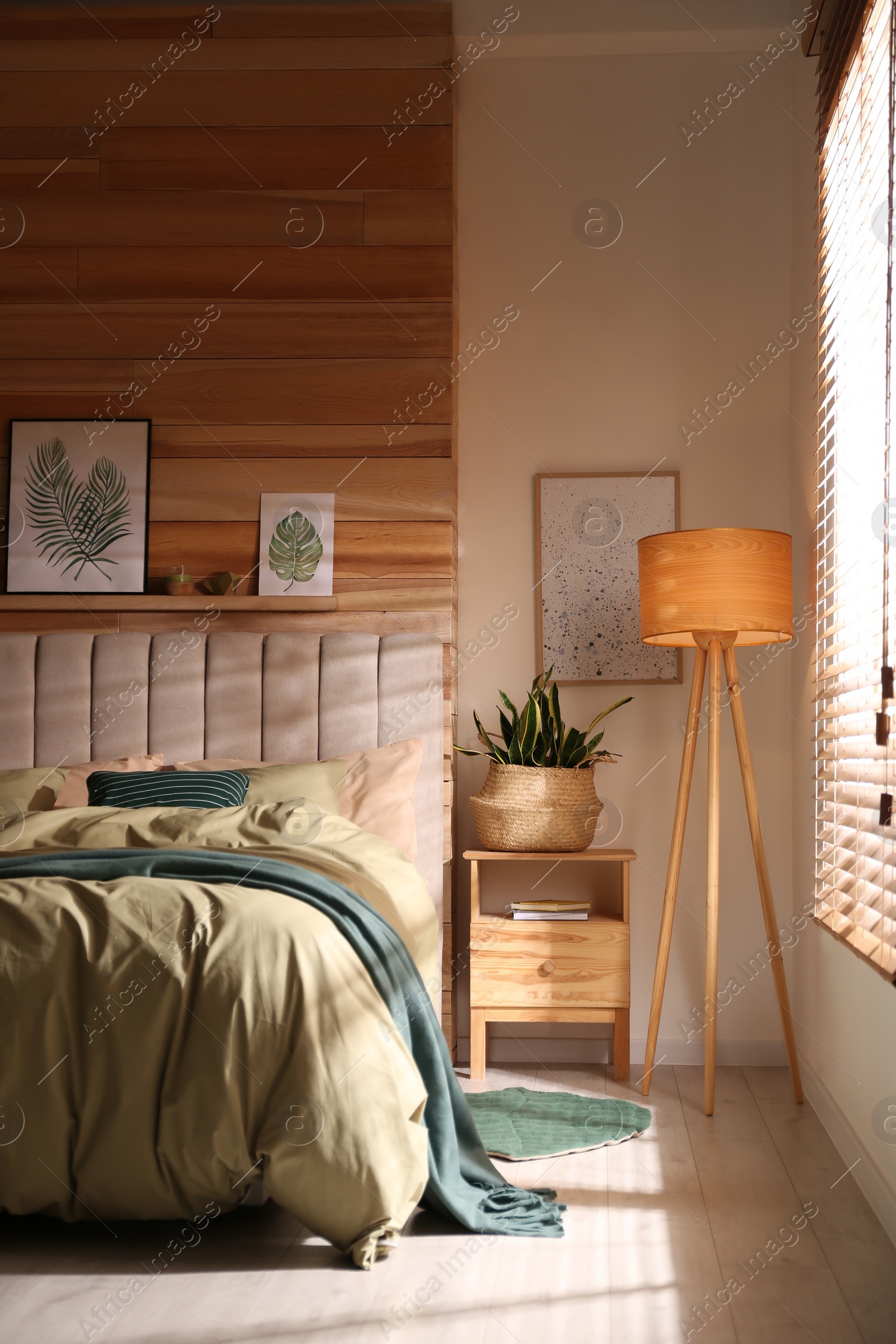 Photo of Comfortable bed with new pistachio linens in modern room interior