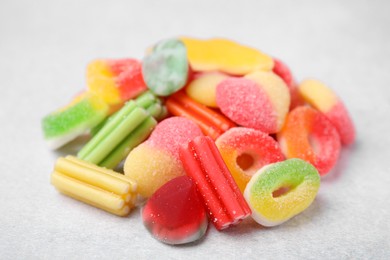 Photo of Pile of tasty colorful jelly candies on white table, closeup