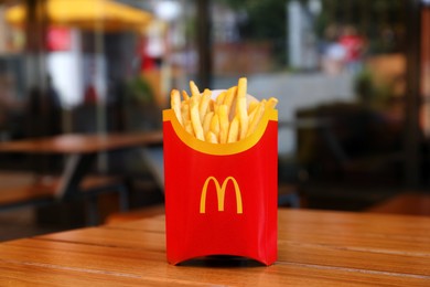 Photo of MYKOLAIV, UKRAINE - AUGUST 11, 2021: Big portion of McDonald's French fries on table in cafe