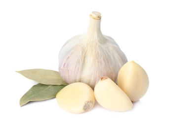 Fresh garlic bulb and cloves with bay leaves isolated on white. Organic food