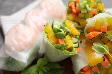 Photo of Tasty spring rolls on grey table, closeup