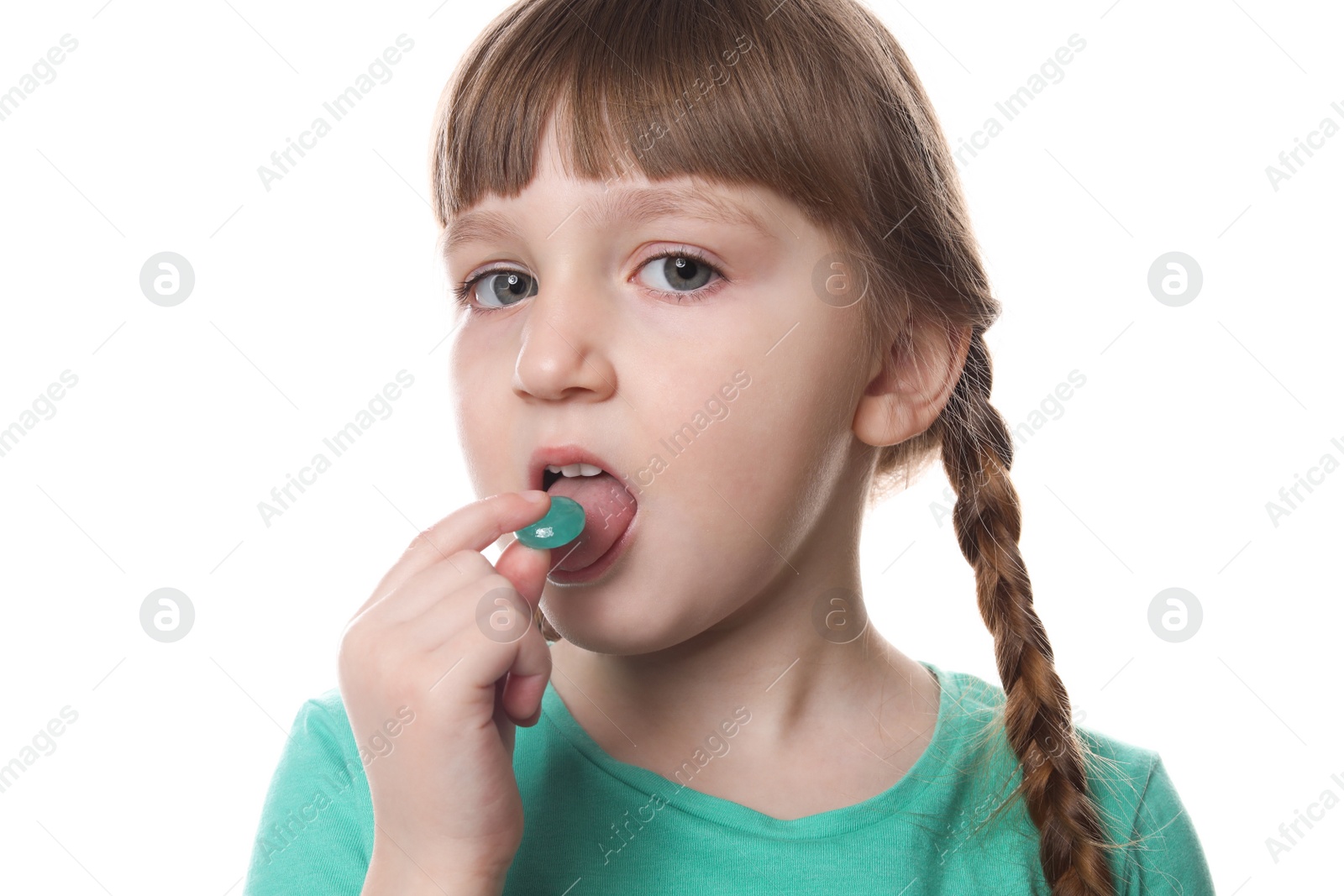 Photo of Little child taking pill on white background. Danger of medicament intoxication