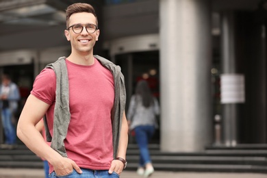 Photo of Portrait of attractive young man in stylish outfit outdoors