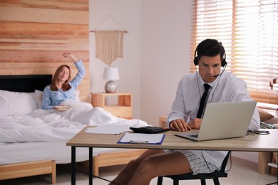 Photo of Man working on laptop in bedroom. Stay at home concept