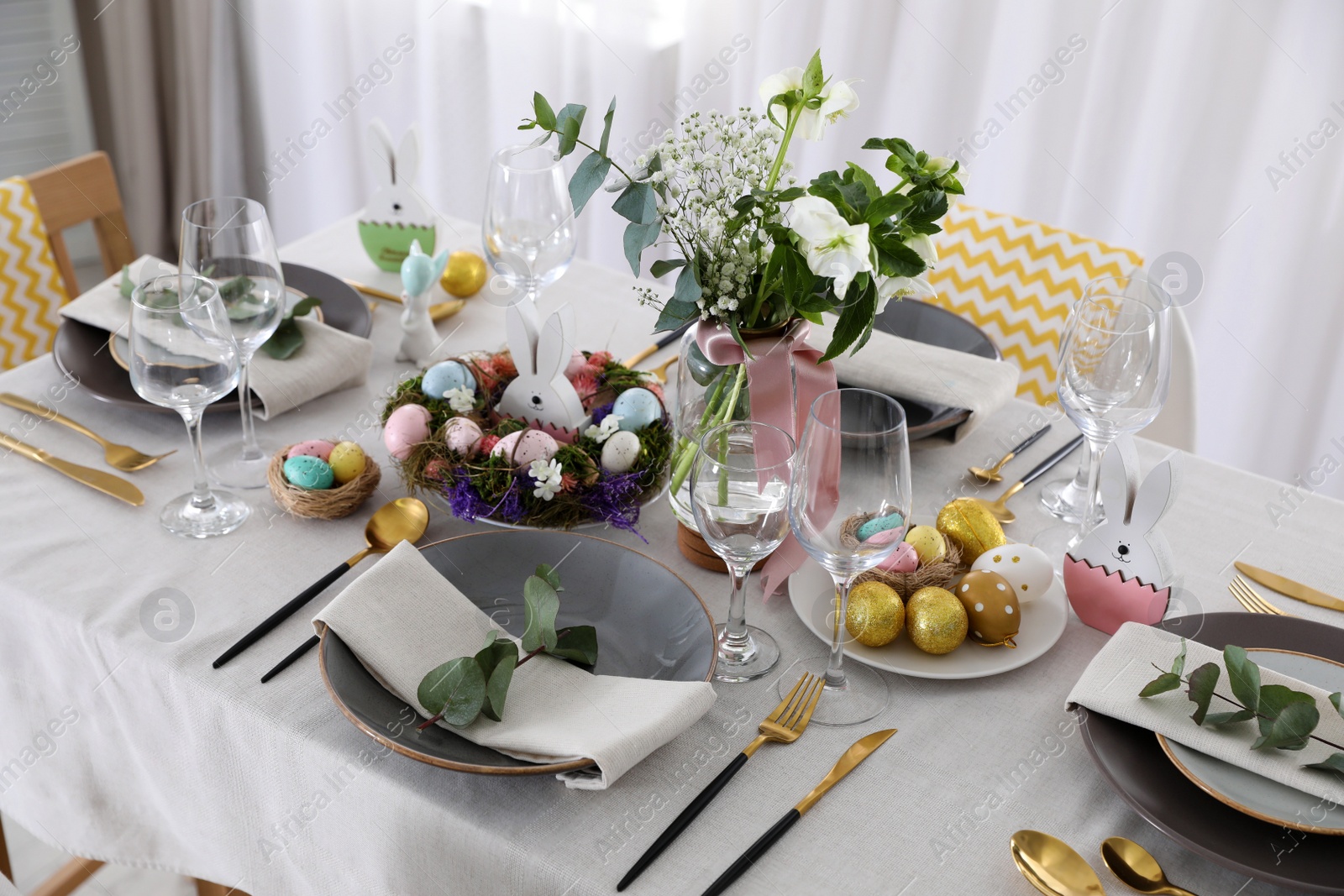 Photo of Beautiful Easter table setting with festive decor indoors