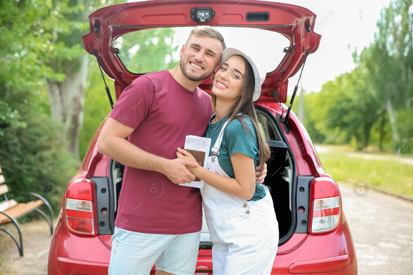 Photo of Beautiful young couple hugging near car